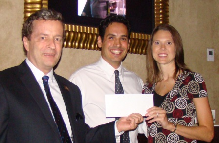 RNASA Treasurer Geoff Atwater and Chairman Rodolfo González present a check to TAS Program Manager Jessica Cejka