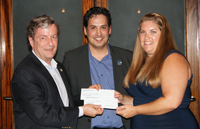 Geoff Atwater and Rodolfo González presenting a check to Stacey Welch